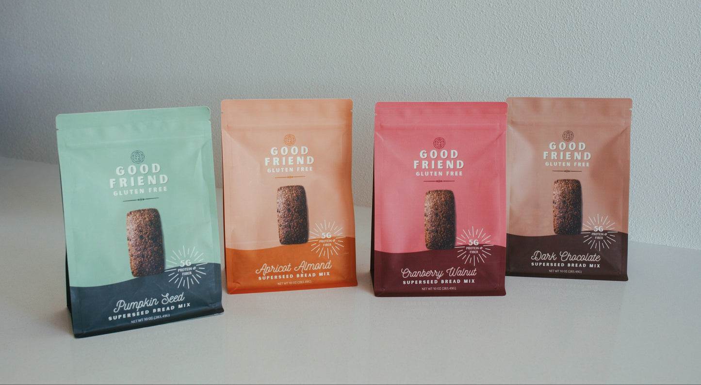 Four packages of 'Good Friend' bread mix on a light gray background