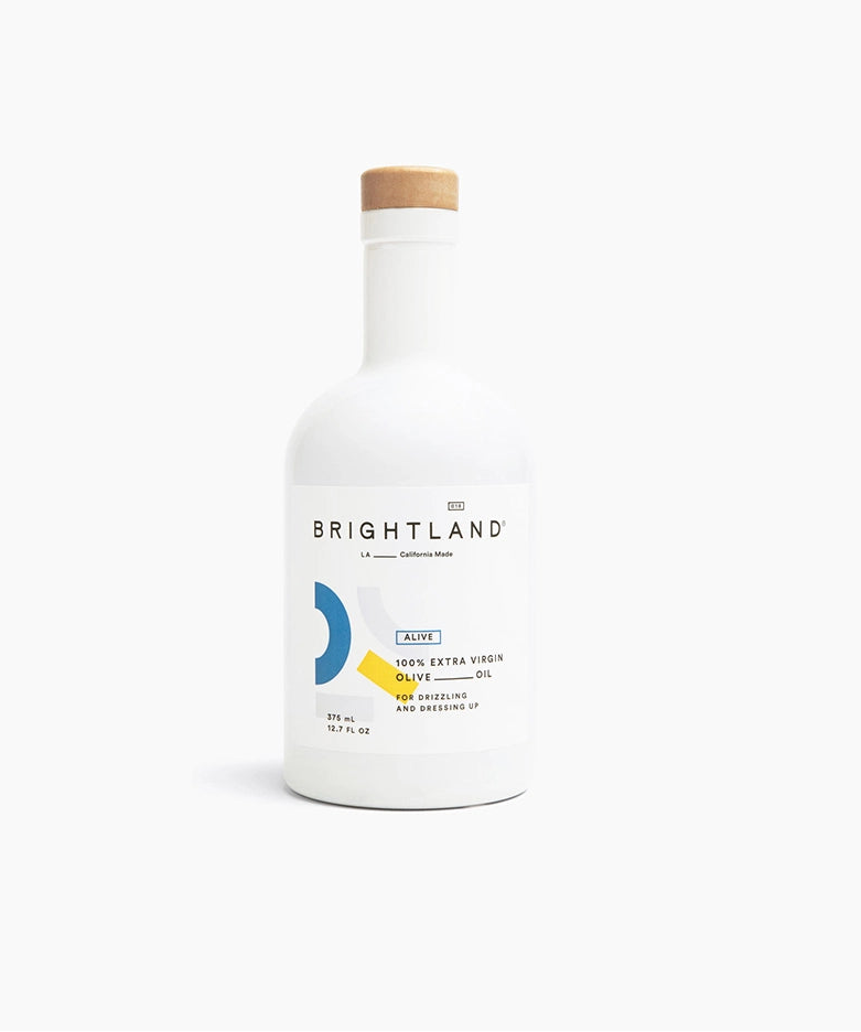 Bottle of Brightland olive oil on a white background